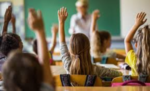 children with raised hands in school
