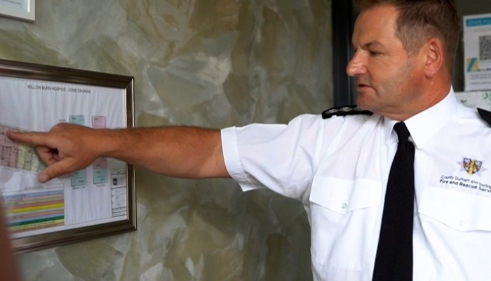 a picture of a business fire safety officer pointing as a map