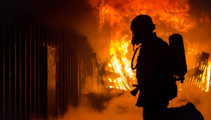 Image of a firefighter silhouette in front of a fire 