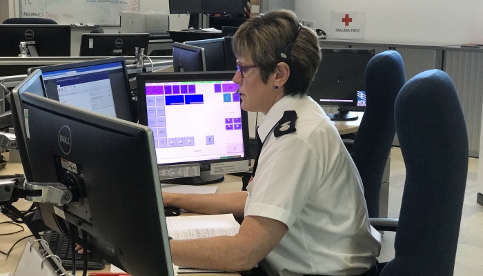A picture of a control operator sitting at their desk looking at the PC monitor