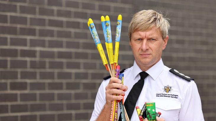 Station Manager Kevin Bell holding fireworks.