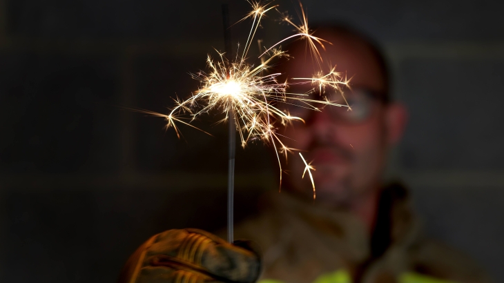 Firefighter holding a sparkler.