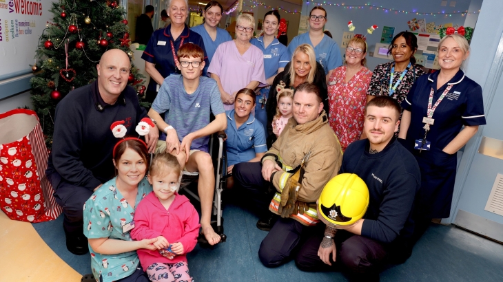 Firefighters visiting youngsters at the University Hospital of North Durham (UHND). Crew pictured with children and hospital staff by Christmas tree.