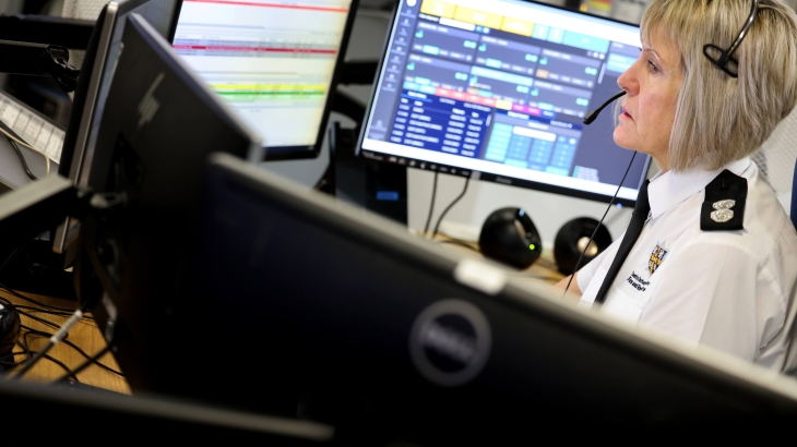 A female control operator looking at several PC monitors