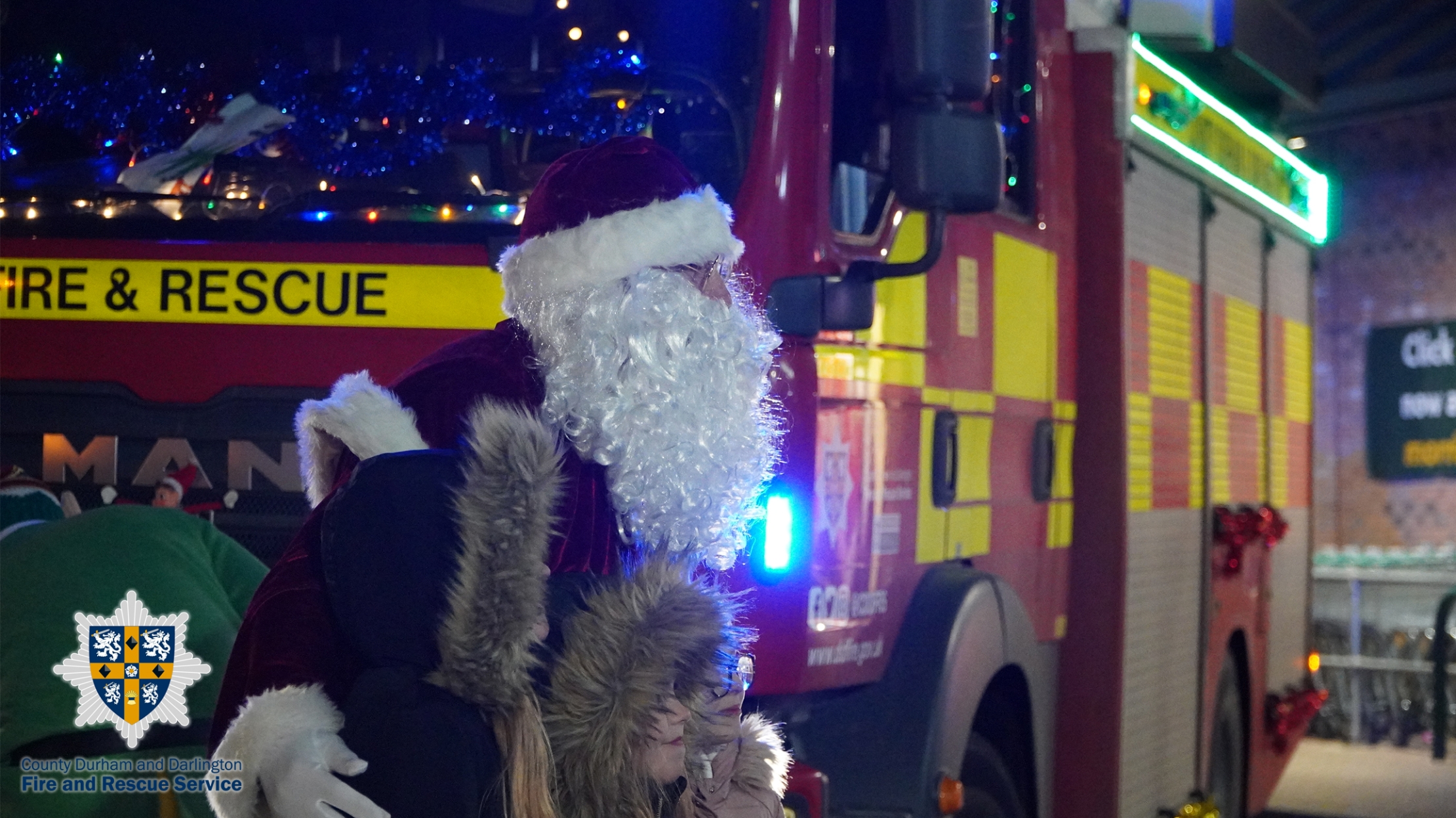 Santa posing infront of a Fire Truck