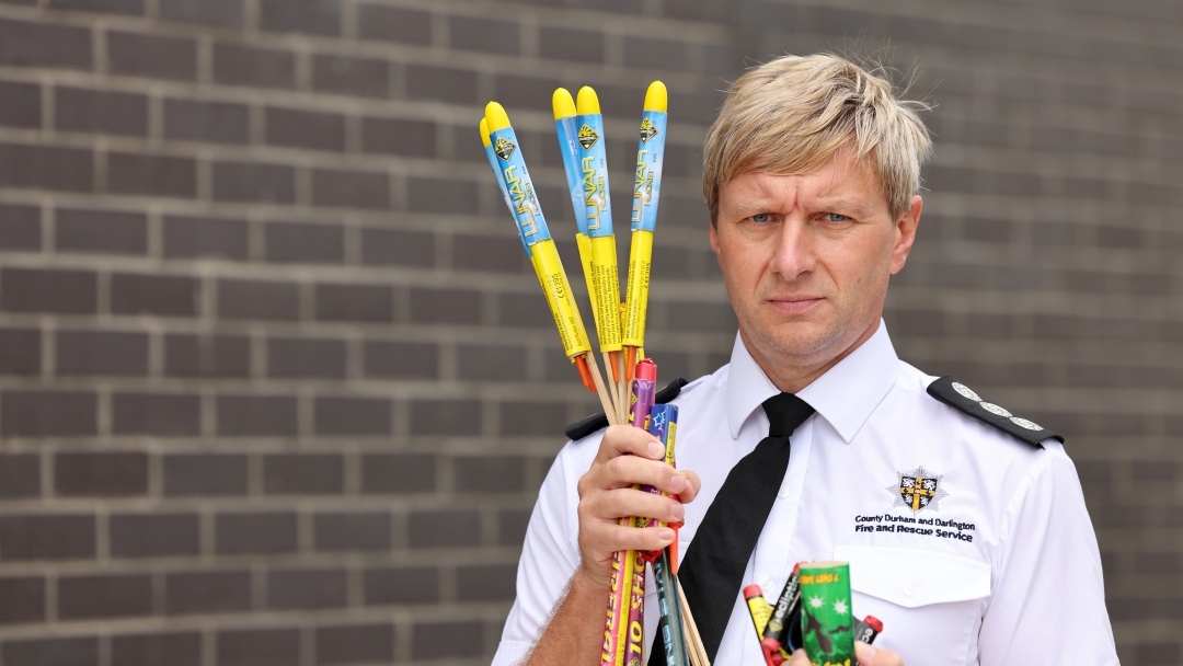 Station Manager Kevin Bell holding fireworks.