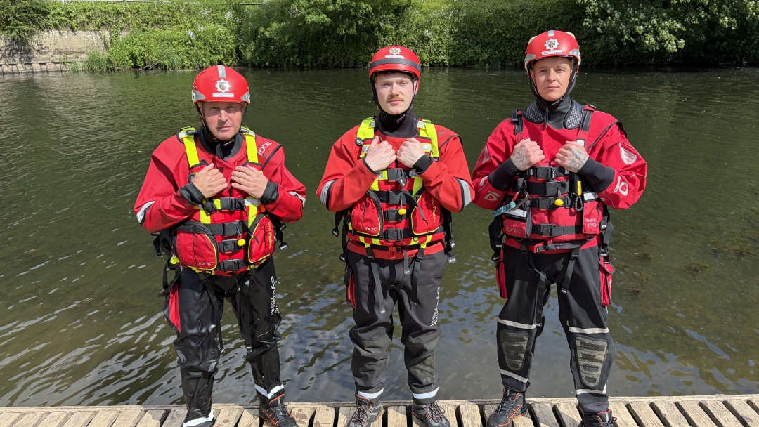 Durham Crew Manager Paul Bainbridge, Firefighters Ethan Hall and Adam Stephenson wearing water kit and standing by a river.